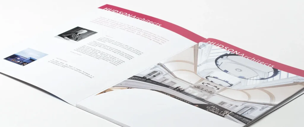 Photograph of the completed Hudson Architects brochure, showing the internal booklets contained within the cover.