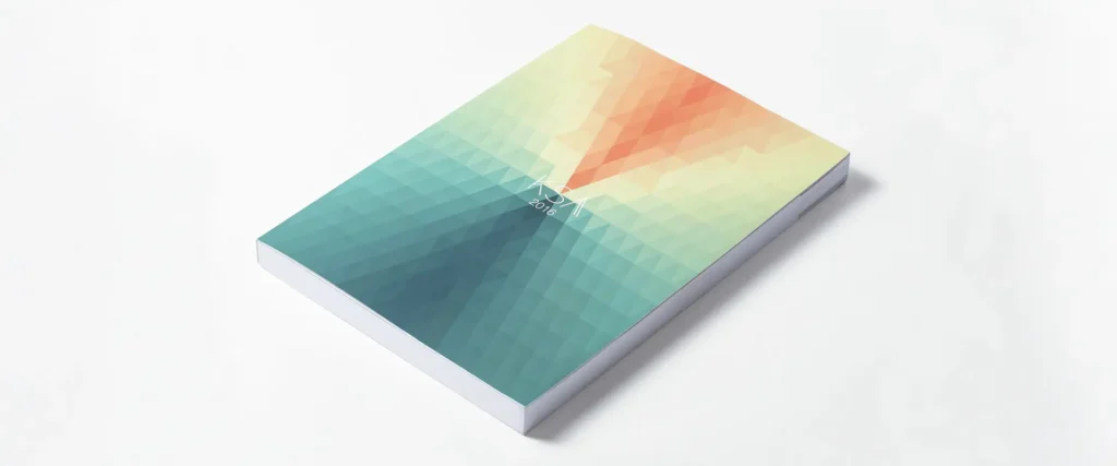 Photograph of the completed Kent School of Architecture book. Image shows the multicoloured cover of the book against a neutral background.